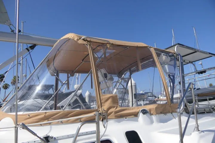 Slide: The Image of Sailboat with tan canopy, Hunter 420 model, 2001, docked under clear blue sky. - 64