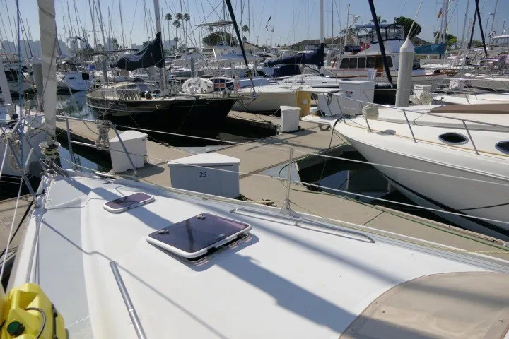 Slide: The Image of Sailboats docked at a marina, featuring a 2001 Hunter 420 in the foreground. - 70