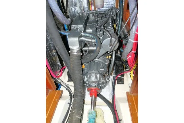Slide: The Image of Engine compartment of a 2001 Hunter 420 sailboat, showcasing mechanical components and wiring. - 95
