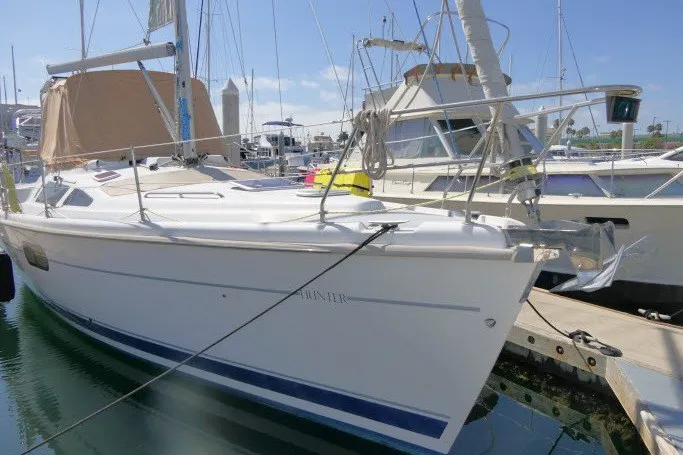 Slide: The Image of 2001 Hunter 420 sailboat docked at marina, surrounded by other boats. - 101