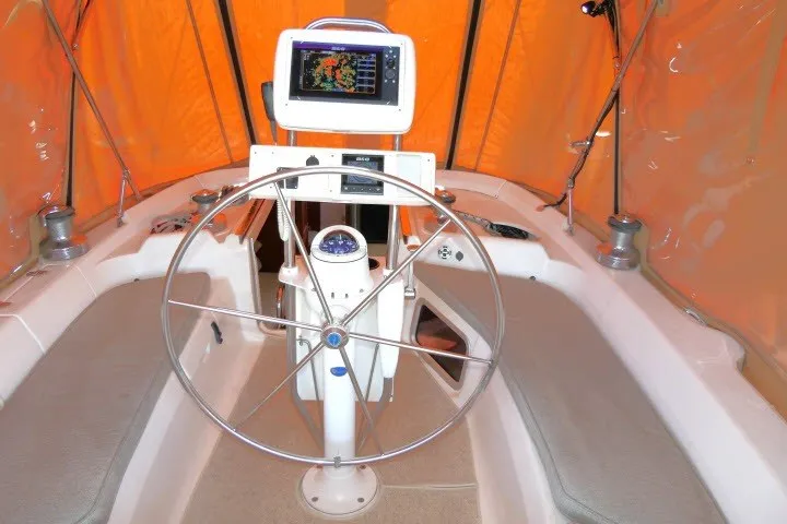 Slide: The Image of Steering wheel and navigation system inside a 2001 Hunter 420 sailboat cockpit. - 37