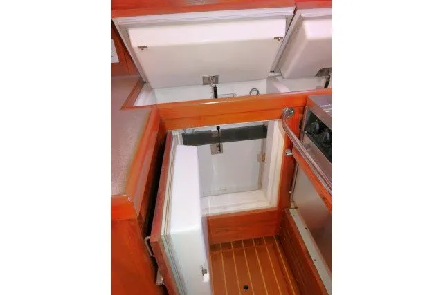 Slide: The Image of Open storage compartments in a 2001 Hunter 420 yacht kitchen area. - 13