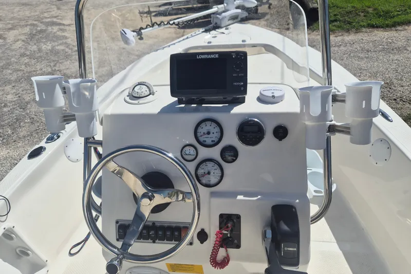 Slide: The Image of 2017 Key West 176 Bay Reef boat dashboard with steering wheel, gauges, and navigation system. - 14