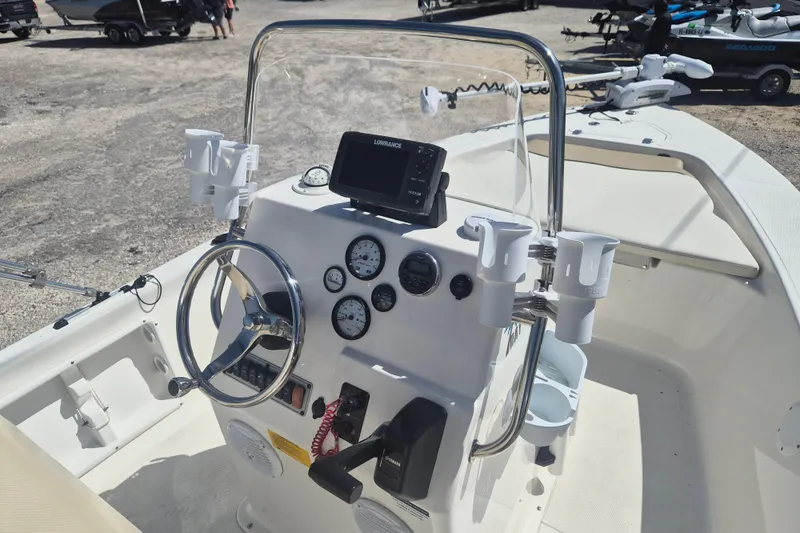 Slide: The Image of 2017 Key West 176 Bay Reef boat console with steering wheel and navigation equipment. - 11