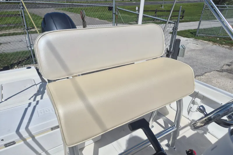 Slide: The Image of 2017 Key West 176 Bay Reef boat seat and console, featuring beige upholstery. - 12