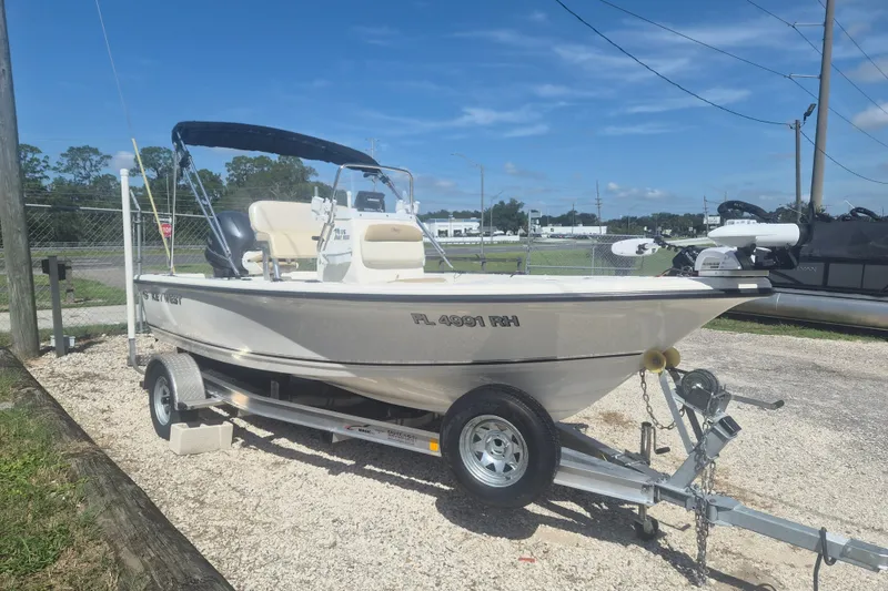 The Image of 2017 Key West 176 Bay Reef boat on trailer, parked outdoors under clear sky. - 1