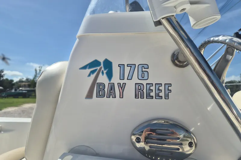 Slide: The Image of 2017 Key West 176 Bay Reef boat logo on white surface, sunny day background. - 23