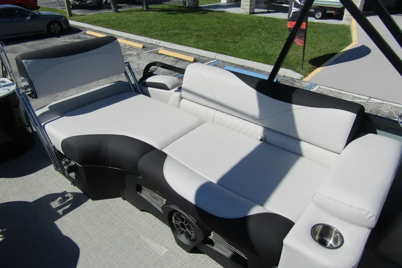 Slide: The Image of 2026 Tahoe Pontoon LTZ Quad Lounger Shift 23 interior with plush seating and cup holder. - 28