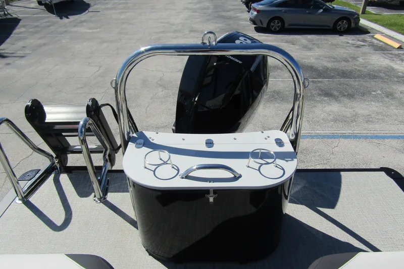 Slide: The Image of 2026 Tahoe Pontoon LTZ Quad Lounger Shift 23, rear view with motor and railing. - 30