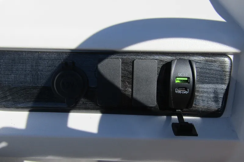 Slide: The Image of Dashboard of 2026 Tahoe Pontoon LTZ Quad Lounger Shift 23 with USB charging ports. - 21