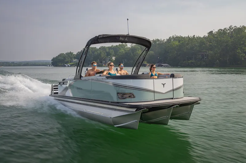 Slide: The Image of 2026 Tahoe Pontoon LTZ Quad Lounger Shift 23 cruising on a serene lake. - 5