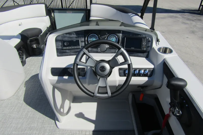 Slide: The Image of 2026 Tahoe Pontoon LTZ Quad Lounger Shift 23 dashboard with steering wheel and controls. - 17