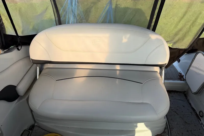 Slide: The Image of 2020 Crownline 264 CR boat interior with white cushioned seating. - 12