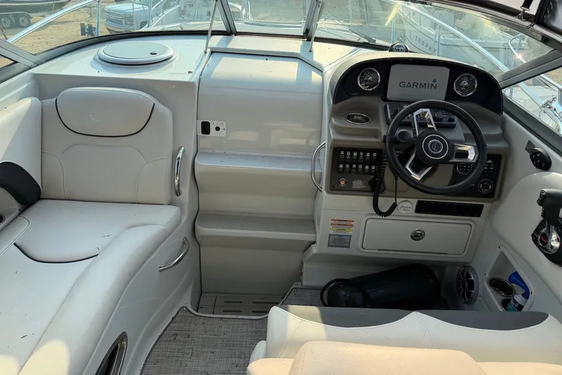 Slide: The Image of 2020 Crownline 264 CR boat cockpit with Garmin navigation system and plush seating. - 15