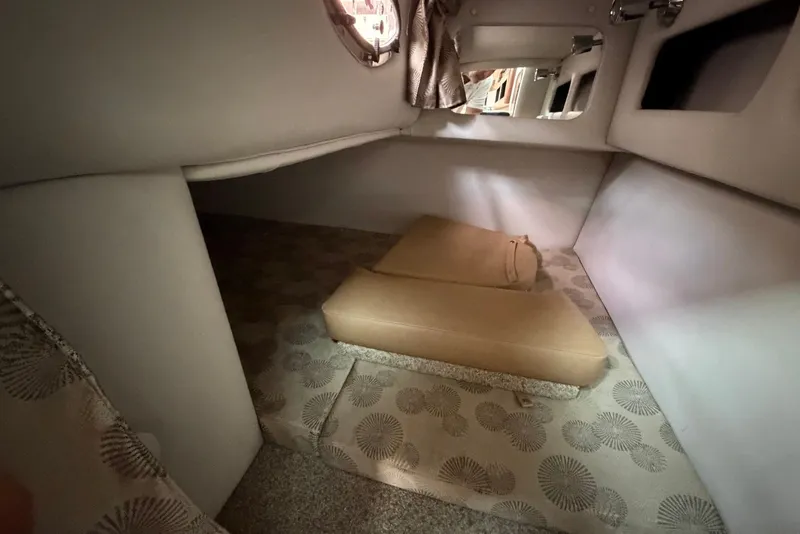 Slide: The Image of 2020 Crownline 264 CR cabin interior with patterned flooring and beige cushions. - 21