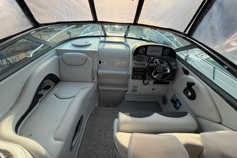 Slide: The Image of Interior of a 2020 Crownline 264 CR boat, featuring a modern helm and seating area. - 7