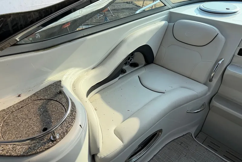 Slide: The Image of 2020 Crownline 264 CR boat interior with white seating and granite countertop. - 14