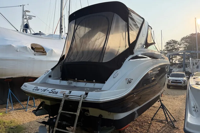 Slide: The Image of 2020 Crownline 264 CR boat on dry dock with protective cover and ladder. - 4