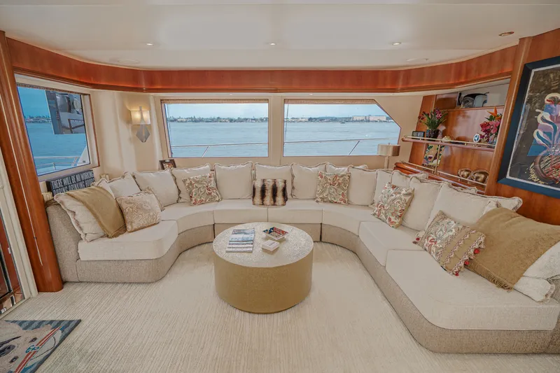 Slide: The Image of Luxurious salon with large windows, comfortable sofas, and a round coffee table, offering stunning water views. - 43