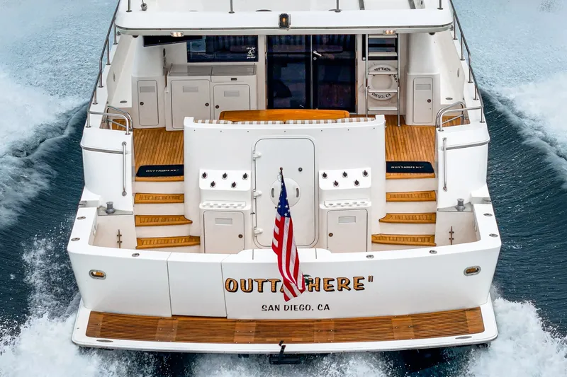 Slide: The Image of The 2005 West Bay 80 CPMY features a sleek aft design with wood decks and an American flag. - 26