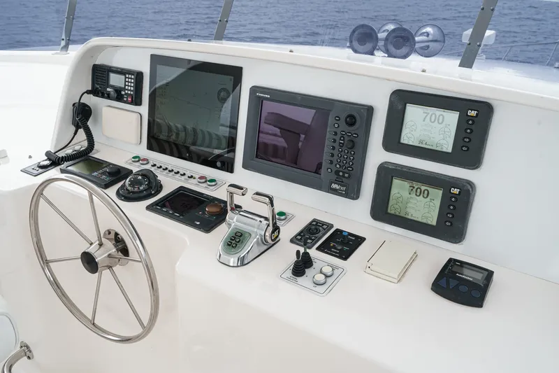 Slide: The Image of The image shows the helm of a 2005 West Bay 80 CPMY with modern navigation equipment. - 23
