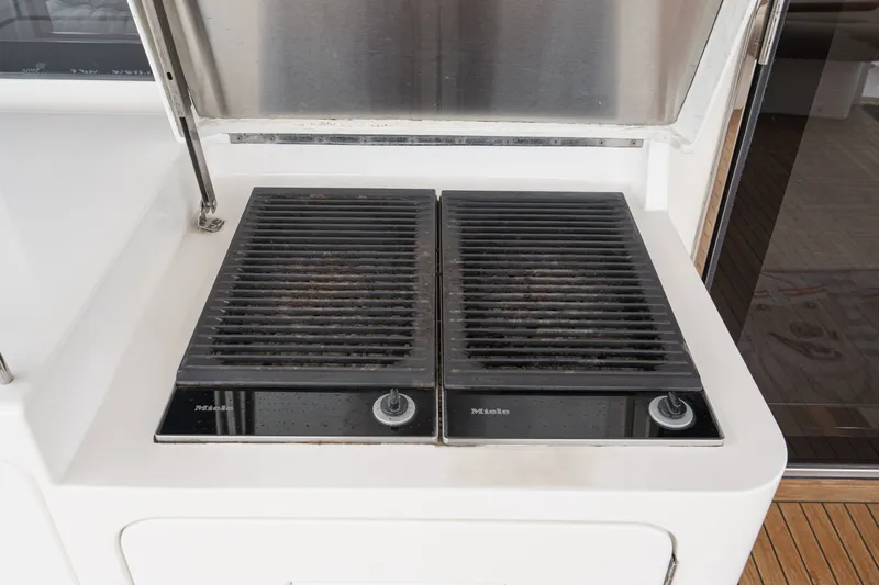 Slide: The Image of A built-in grill with two Miele cooktops on a boat. - 36