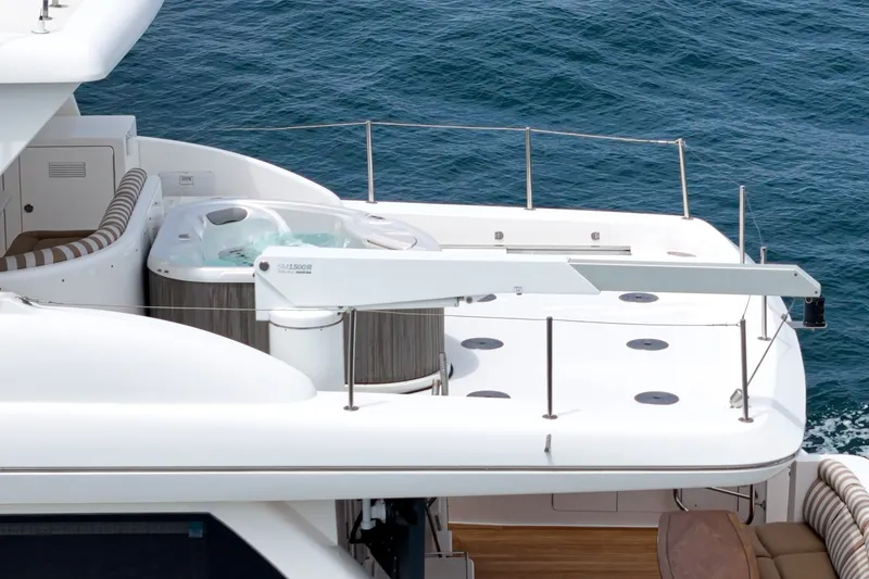 Slide: The Image of The 2005 West Bay 80 CPMY features a luxurious deck with a hot tub and seating area. - 17