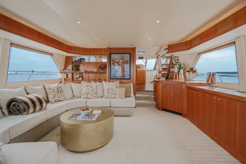 Slide: The Image of Luxurious salon with cream sofa, round coffee table, and large windows offering sea views. - 40