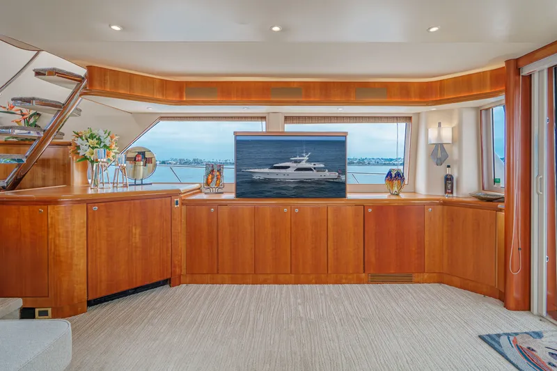 Slide: The Image of Luxurious salon with wooden cabinetry and large windows offering a view of the sea. - 44