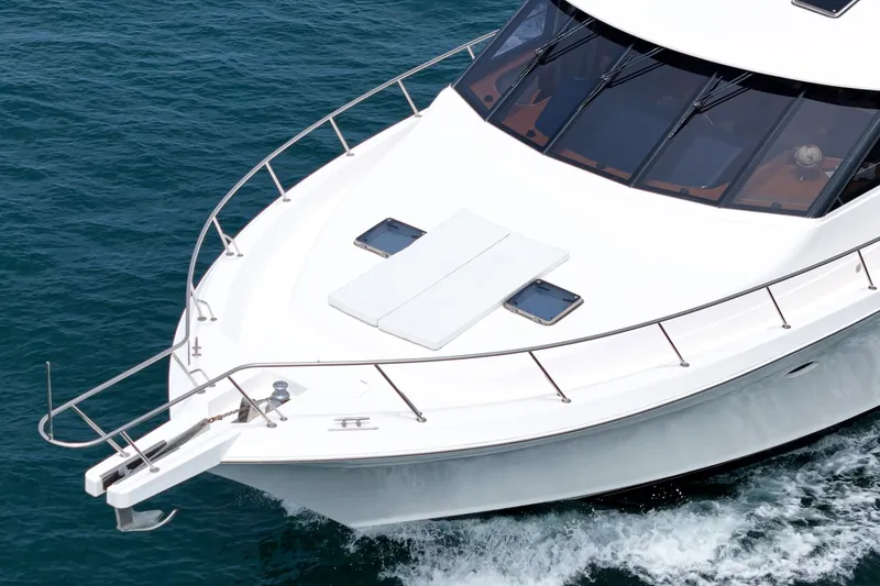 Slide: The Image of The 2005 West Bay 80 CPMY glides elegantly over blue water. The deck is spacious and modern. - 10