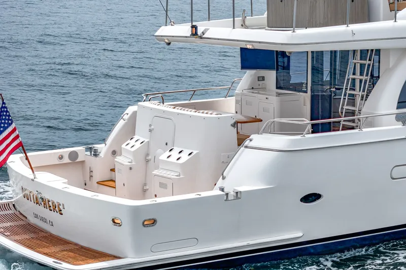 Slide: The Image of The 2005 West Bay 80 CPMY features a spacious aft deck with seating and an American flag. - 33