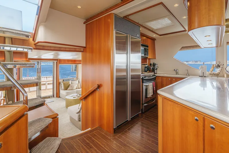 Slide: The Image of The luxurious interior of a 2005 West Bay 80 CPMY with wood flooring and a modern kitchen. - 48