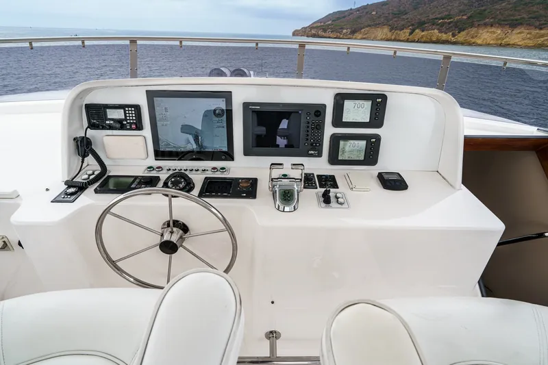 Slide: The Image of The image shows the helm of a 2005 West Bay 80 CPMY with multiple screens and instruments. - 24