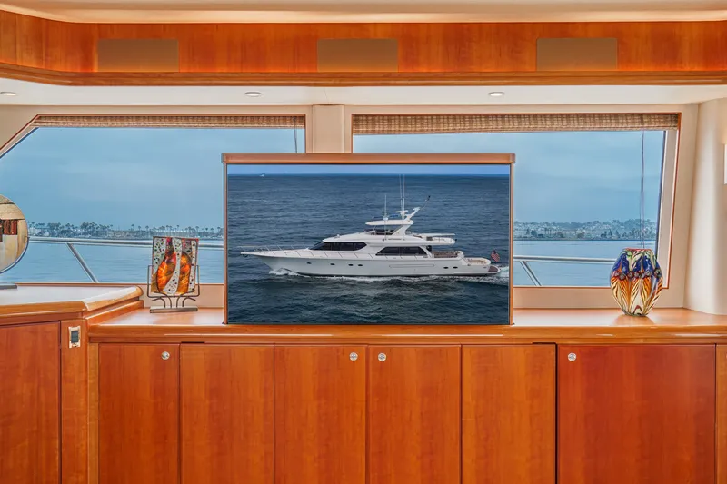 Slide: The Image of Interior view of a luxury yacht with wooden furnishings and a large window overlooking the sea. - 45