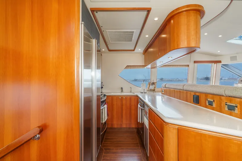 Slide: The Image of The 2005 West Bay 80 CPMY kitchen features elegant wood cabinetry and modern appliances. - 49