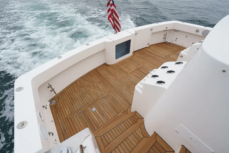 Slide: The Image of The image shows the teak deck of a 2005 West Bay 80 CPMY with a U.S. flag. - 29