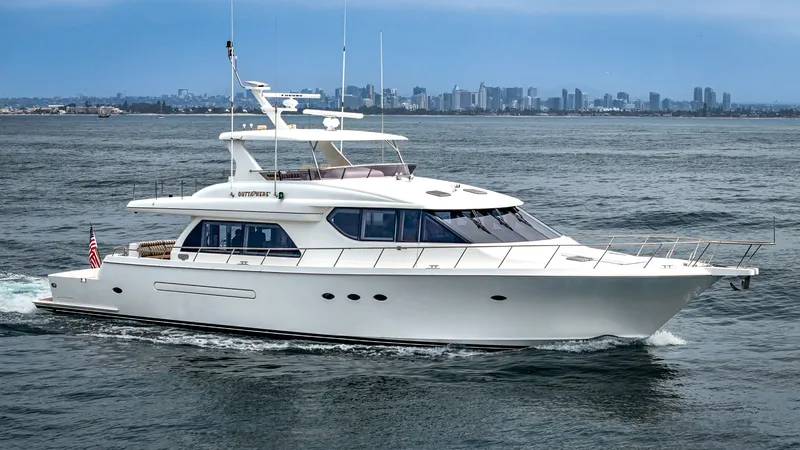 Slide: The Image of A sleek white yacht cruises on the water with a city skyline in the background. - 1