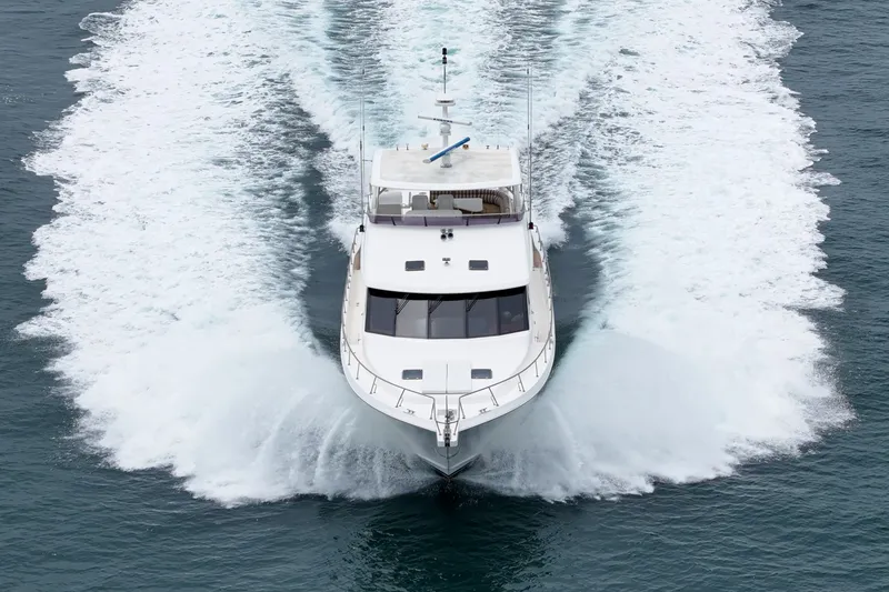Slide: The Image of A 2005 West Bay 80 CPMY yacht speeds across the water, leaving a white wake behind. - 8