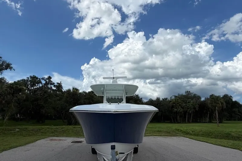 Slide: The Image of 2012 Bahama 37 boat on trailer under cloudy sky, front view. - 7