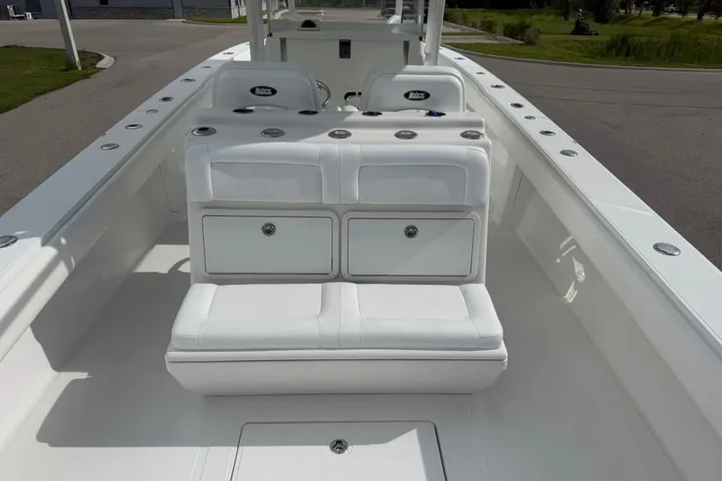 Slide: The Image of 2012 Bahama 37 boat interior with white seating and storage compartments. - 14