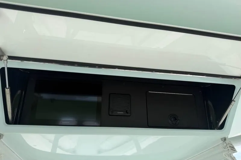 Slide: The Image of 2012 Bahama 37 boat dashboard with electronic display and storage compartment. - 12