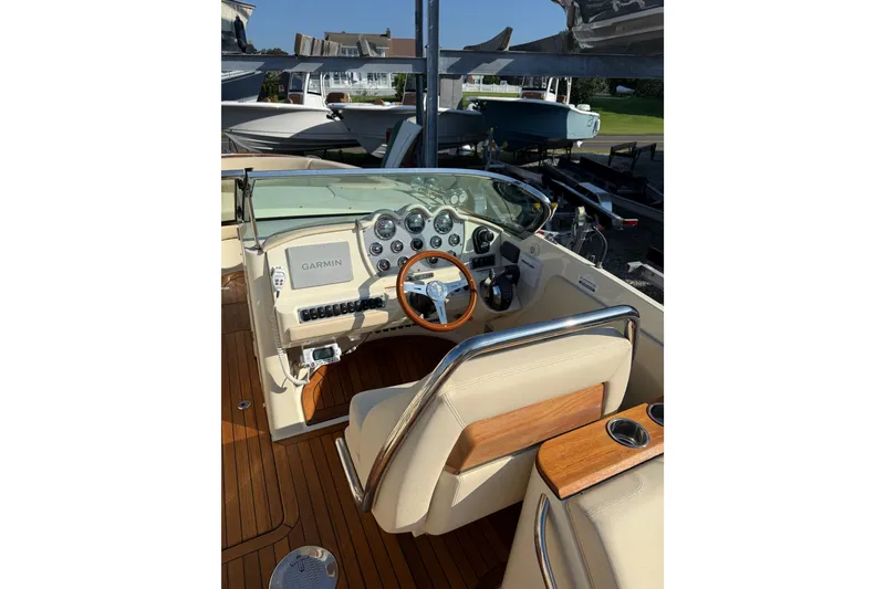 Slide: The Image of 2018 Chris-Craft Launch 30 cockpit with Garmin navigation, wooden accents, and beige seating. - 3