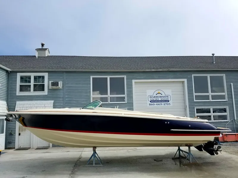 The Image of 2018 Chris-Craft Launch 30 on a trailer in front of a blue building. - 0