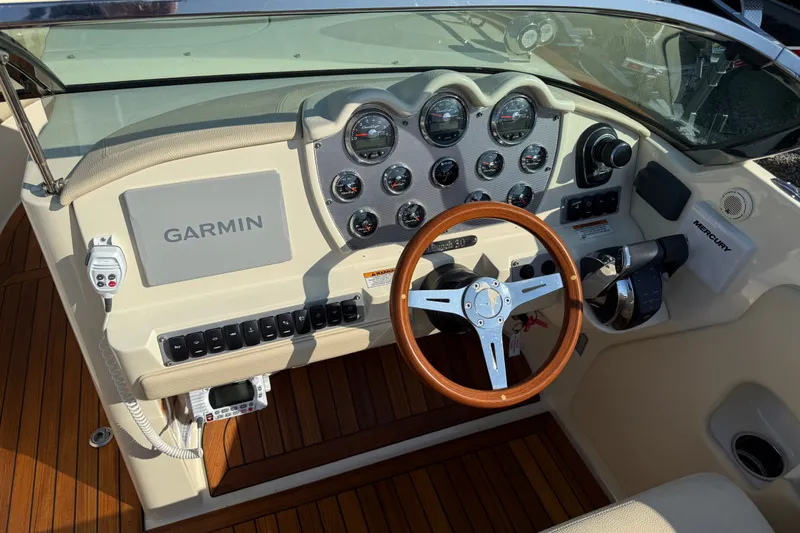 Slide: The Image of 2018 Chris-Craft Launch 30 dashboard with Garmin navigation and wooden steering wheel. - 5
