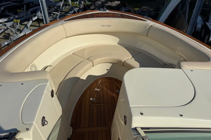 Slide: The Image of 2018 Chris-Craft Launch 30 boat interior with beige seating and wooden flooring. - 6