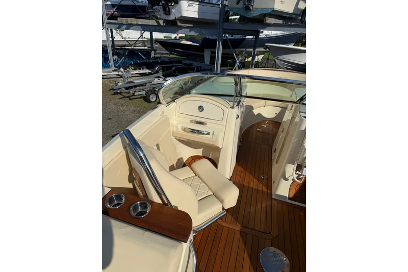 Slide: The Image of 2018 Chris-Craft Launch 30 interior with beige seating and wooden flooring. - 4