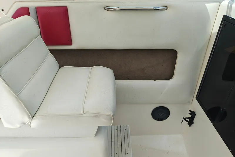 Slide: The Image of White interior seating of a 1996 SportsCraft 232HT boat with red accents. - 22