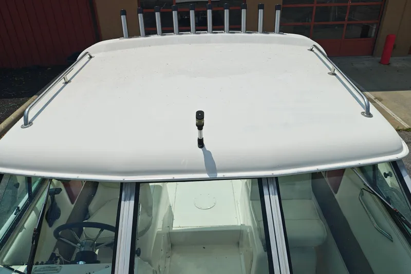 Slide: The Image of 1996 SportsCraft 232HT boat roof with rod holders and railing, viewed from above. - 35