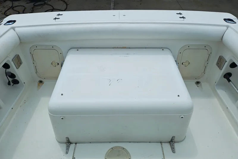 Slide: The Image of 1996 SportsCraft 232HT boat interior with storage compartments and seating area. - 13
