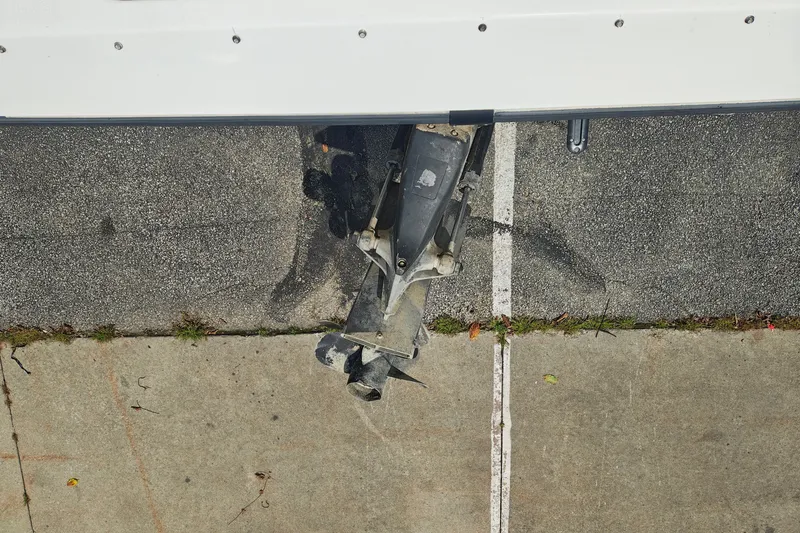 Slide: The Image of Overhead view of a 1996 SportsCraft 232HT boat motor on pavement. - 9